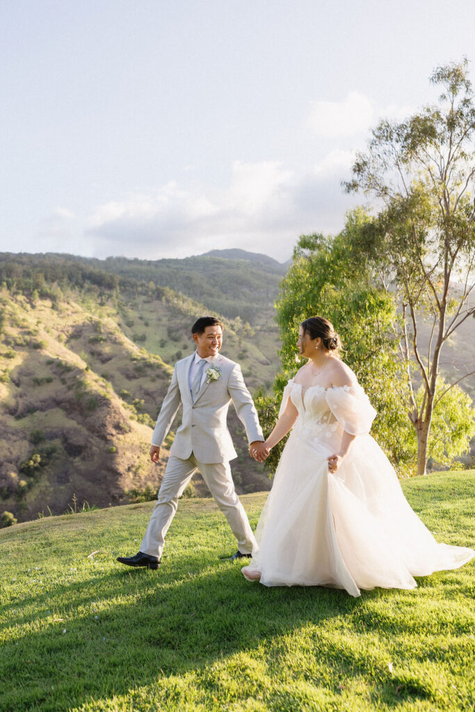 portrait of the bride and groom holding hands