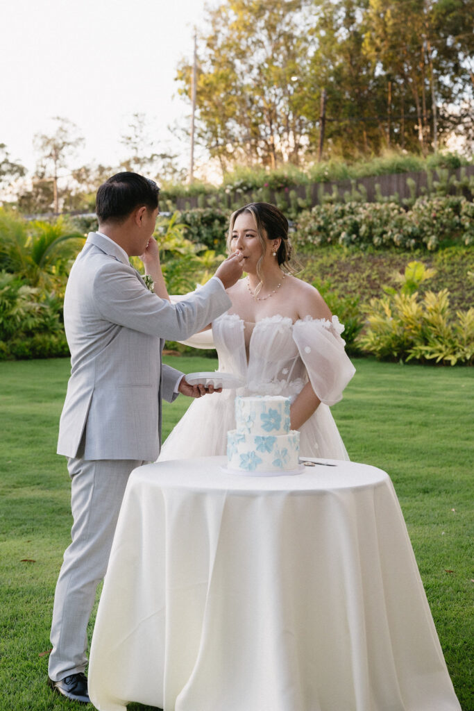 cute picture of the newly married couple cutting their wedding cake
