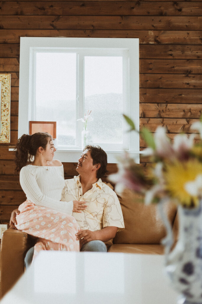 picture of the newly engaged couple smiling at each other