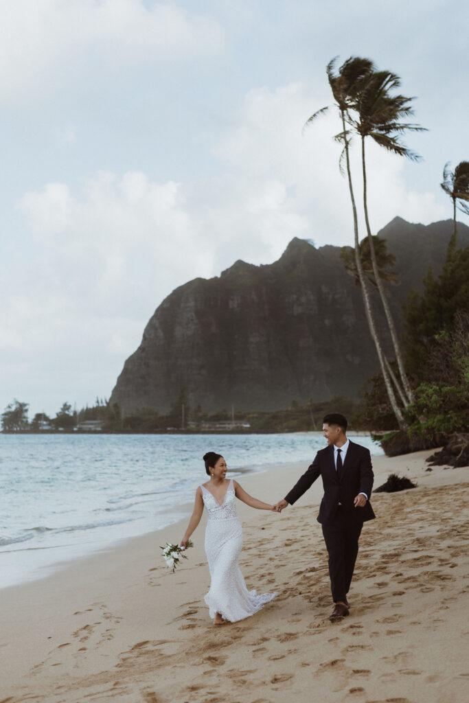 cute picture of the newlyweds walking around the beach