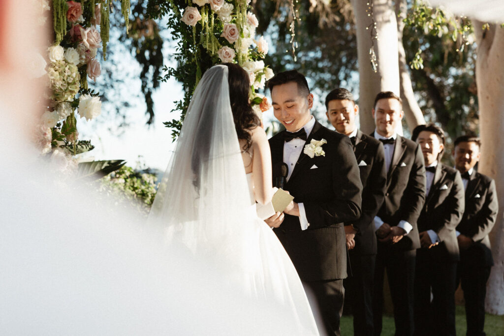 bride and groom holding hands during their wedding ceremony