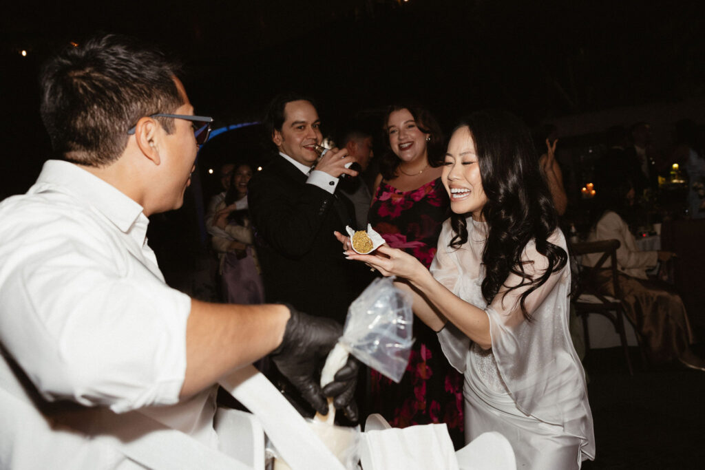 newlyweds trying their wedding cake