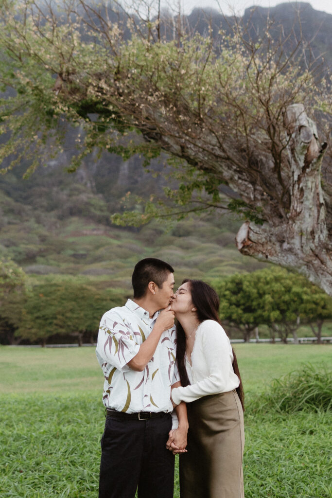 cute picture of the newly engaged couple kissing