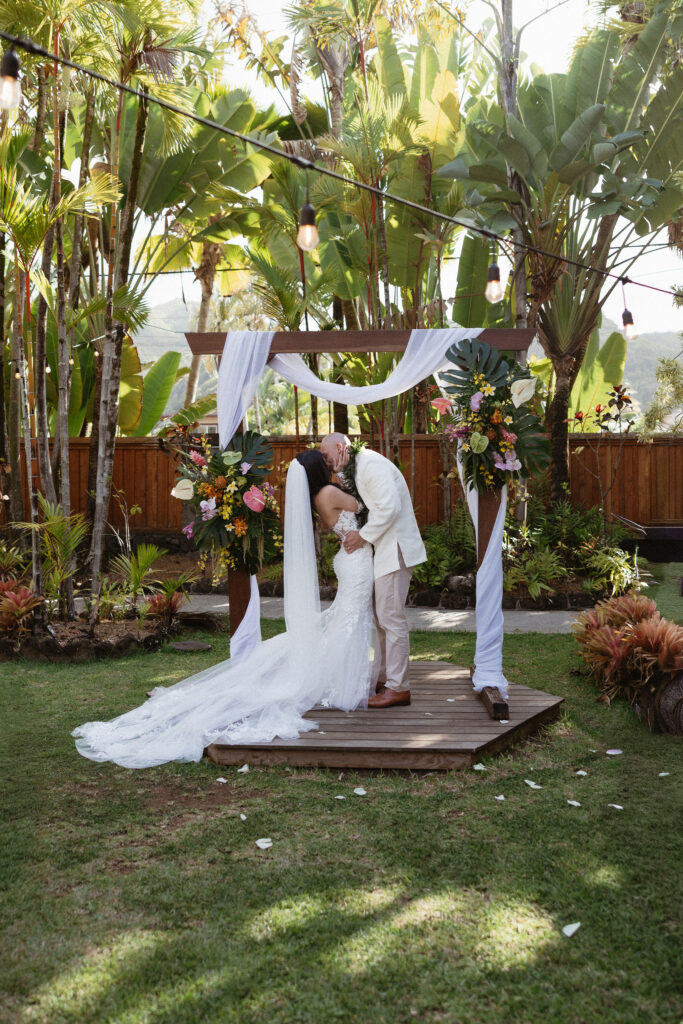 portrait of the bride and groom kissing after their ceremony
