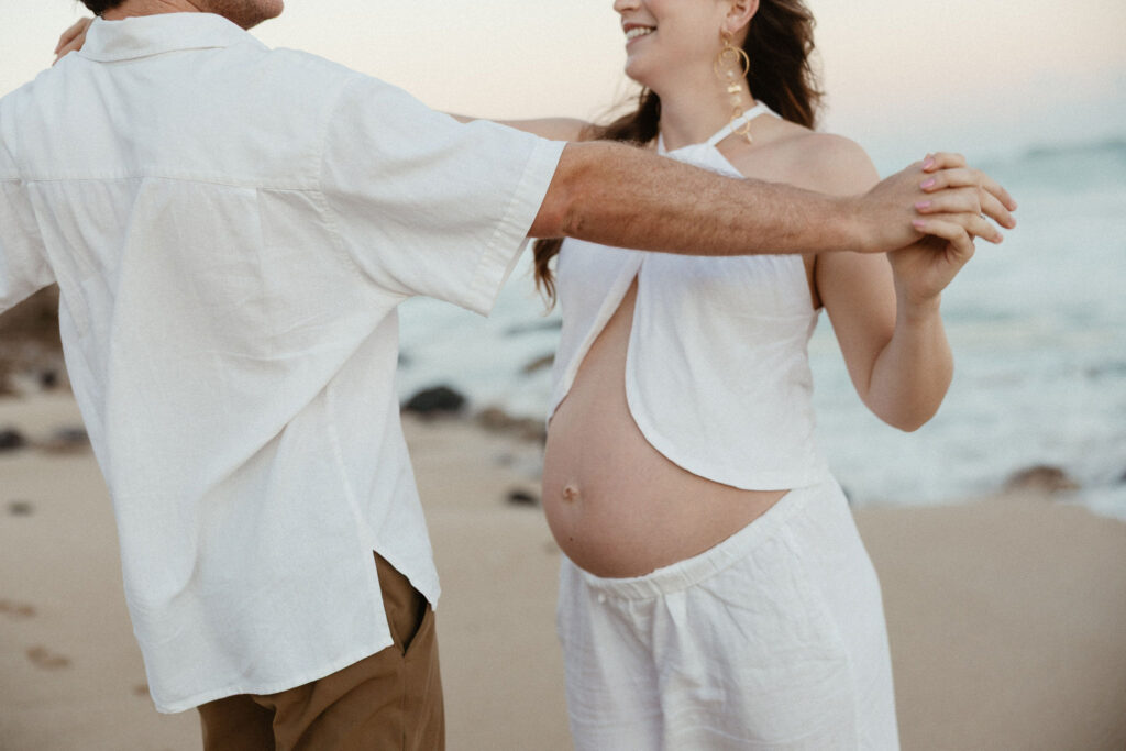 couple at their beach maternity session