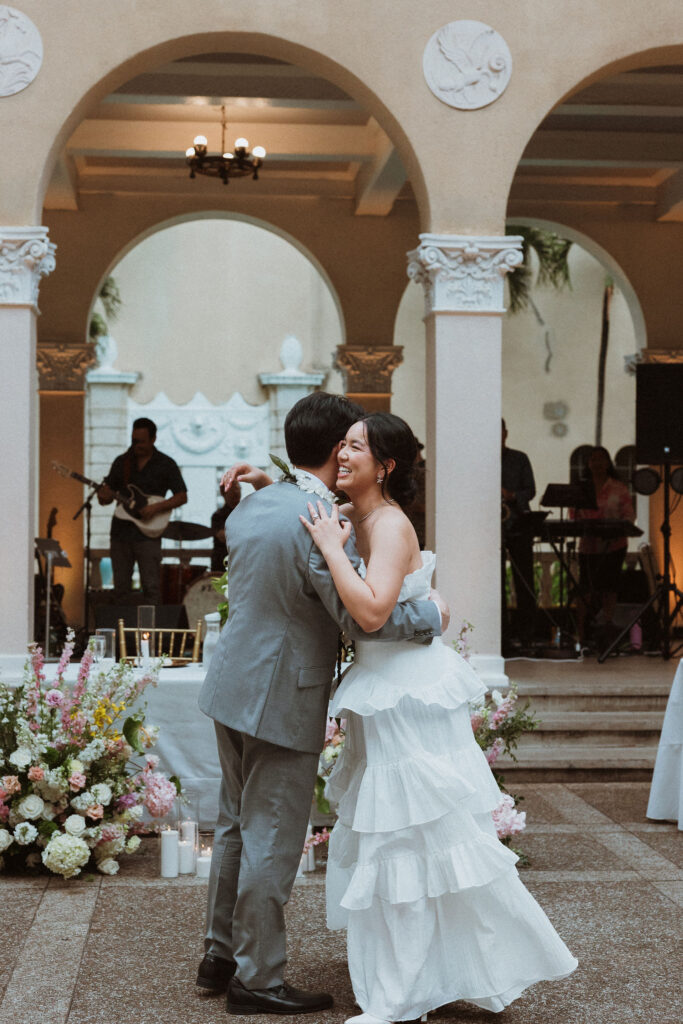newlyweds hugging at their wedding reception