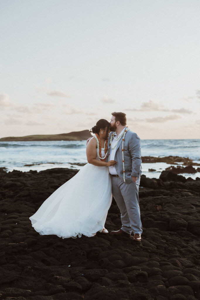 groom kissing the bride on the forehead