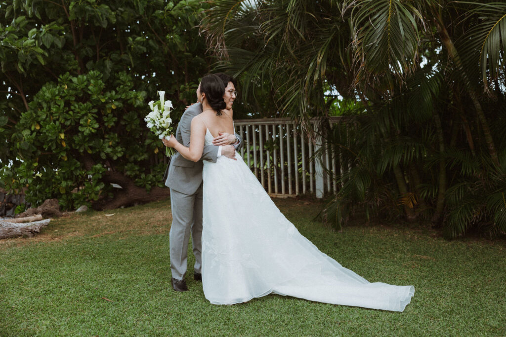 cute picture of the bride and groom hugging after their first look