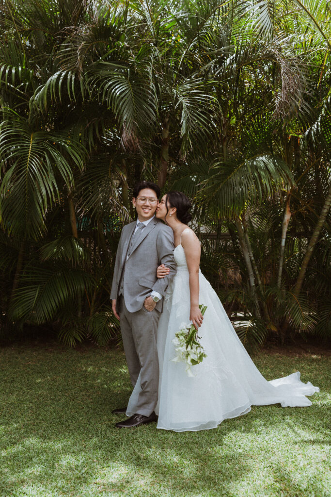 bride kissing the groom on the cheek