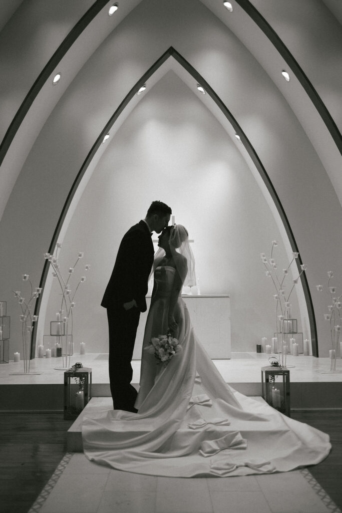 groom kissing the bride on the forehead