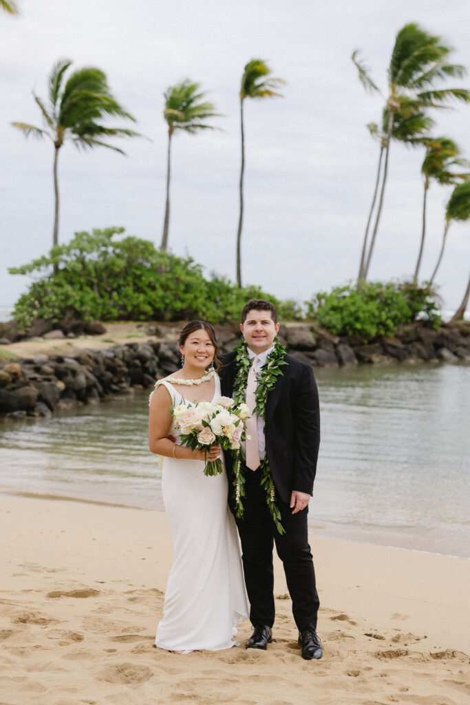 newlyweds smiling at the camera during their photoshoot