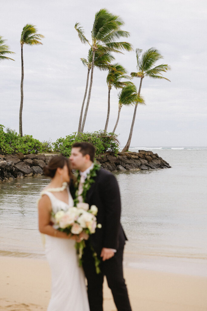 groom kissing the bride on the forehead