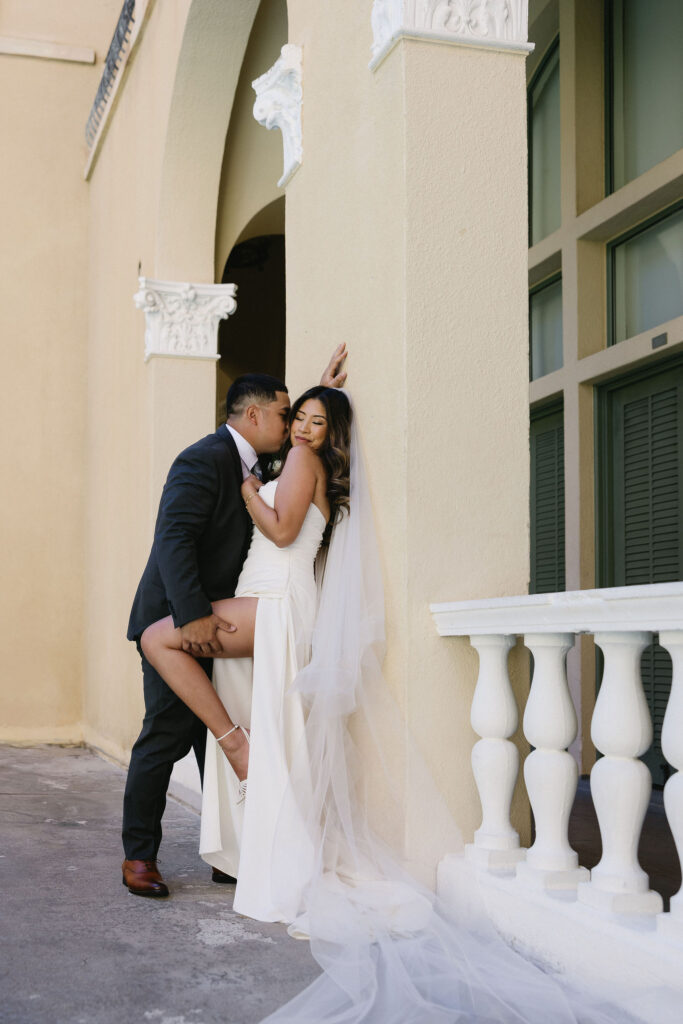 groom kissing the bride on the cheek