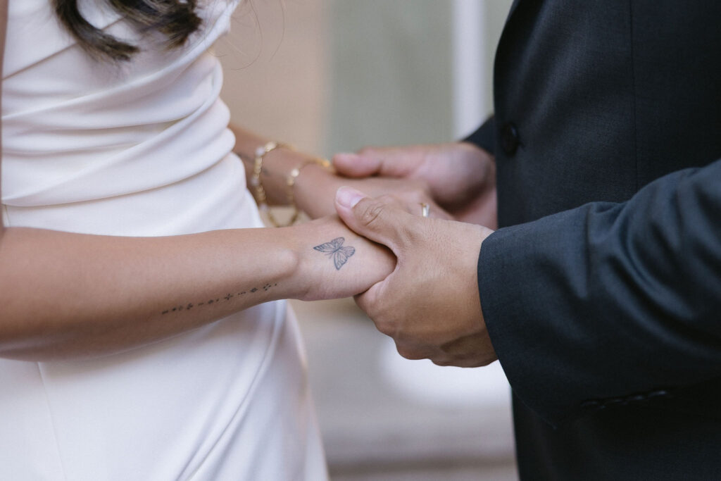 bride and groom holding hands during their ceremony