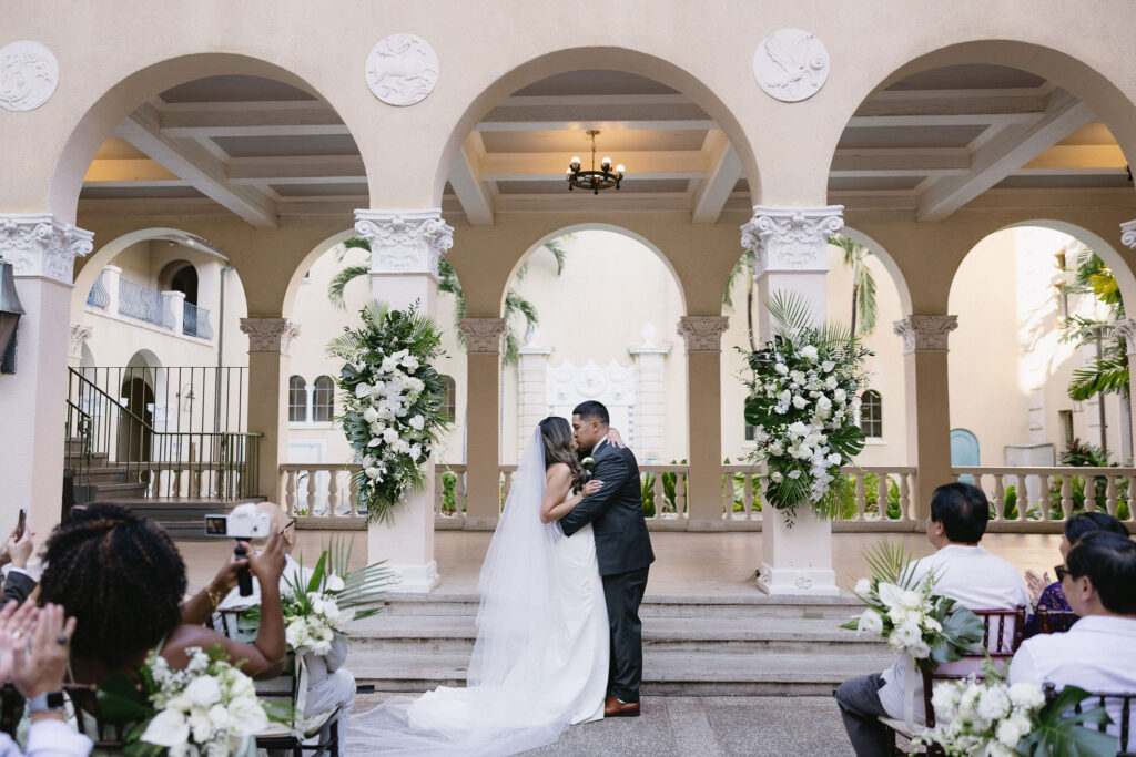 portrait of the newlyweds kissing after their ceremony