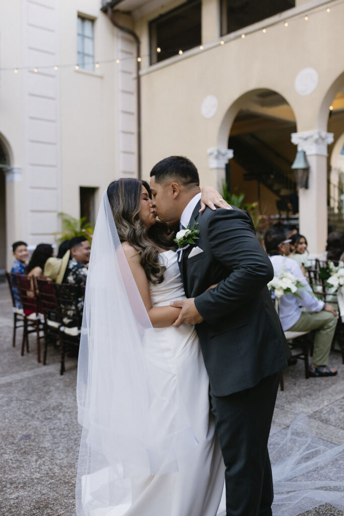 cute picture of the newlyweds kissing at their wedding reception