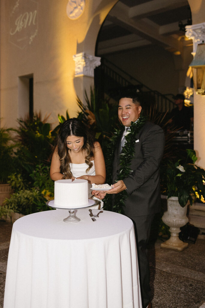 cute picture of the newlyweds cutting their wedding cake