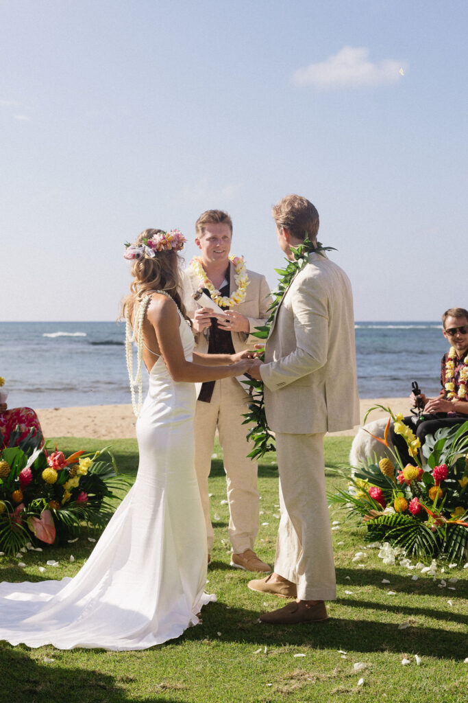 cute picture of the bride and groom holding hands during their ceremony