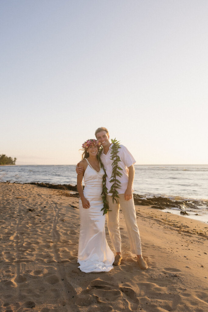 newlyweds smiling at the camera during their photoshoot