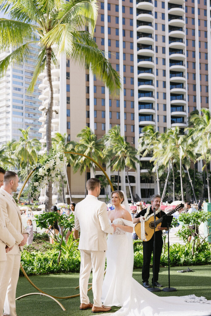 cute picture of the bride and groom holding hands during their ceremony