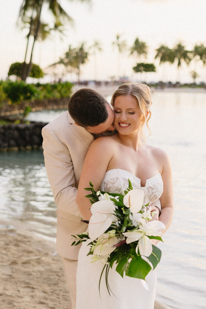 groom kissing the bride on the cheek