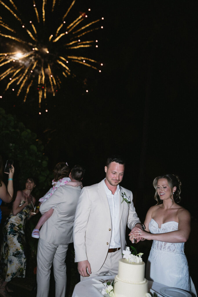 newlyweds cutting their wedding cake