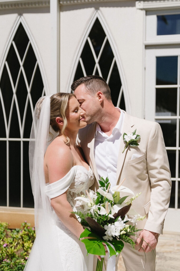 groom kissing the bride on the cheek