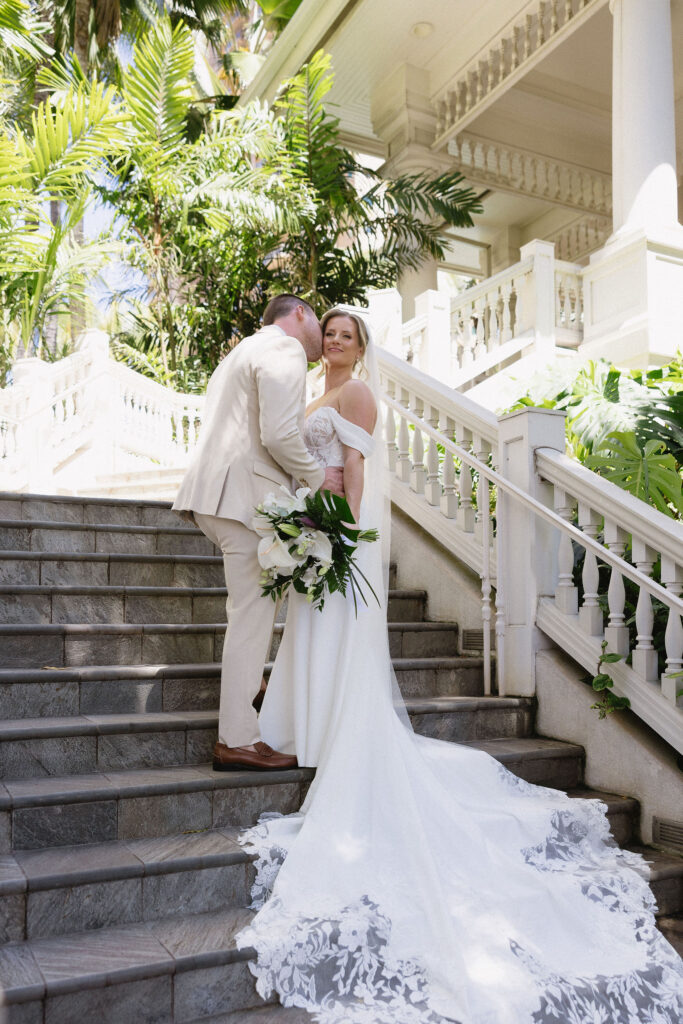 portrait of the groom kissing the bride on the cheek