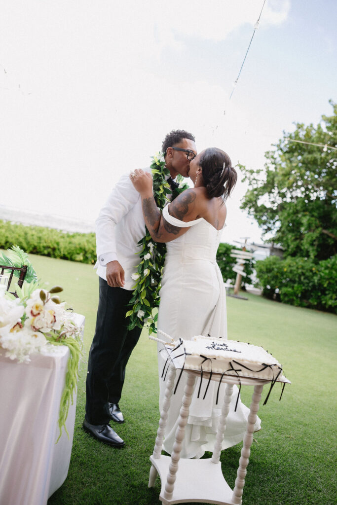 newlyweds trying their wedding cake